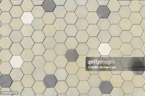 grey hexagon-shaped paving stones - abundance tiles stock pictures, royalty-free photos & images