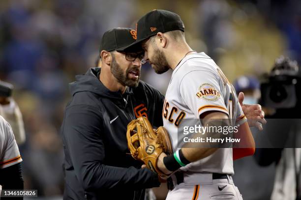 Manager Gabe Kapler celebrates with Evan Longoria of the San Francisco Giants after beating the Los Angeles Dodgers 1-0 in game 3 of the National...