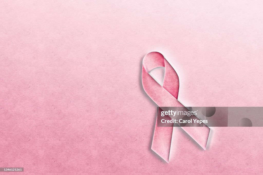 Breast Cancer Awareness Ribbon in paper cut.Pink background
