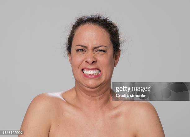 close-up of mid adult woman with disgusting facial expression - ugly woman stock pictures, royalty-free photos & images