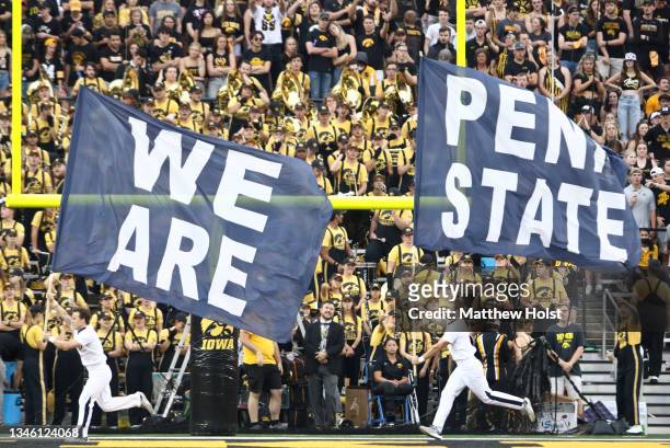 Cheerleaders carry flags to celebrate a field goal by Penn State Nittany Lions during the second half against the Iowa Hawkeyes at Kinnick Stadium on...