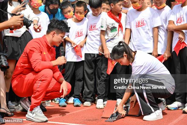 Chinese sprinter Su Bingtian visits his alma mater, the Zhongshan Sports School, on October 12, 2021 in Zhongshan, Guangdong Province of China.