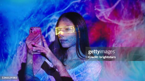 video projection on a woman using a smart phone - augmented reality phone stock pictures, royalty-free photos & images