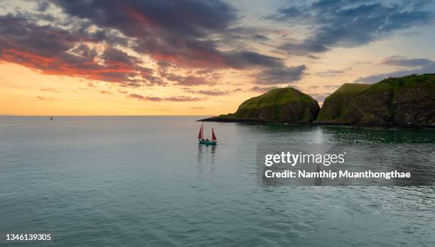 beautiful scenery of the sailing boat located the north sea under the beauty sky in the sunset time shows the fishermen is fishing the fish near the coastline of the united kingdom. - scottish coastline stock pictures, royalty-free photos & images