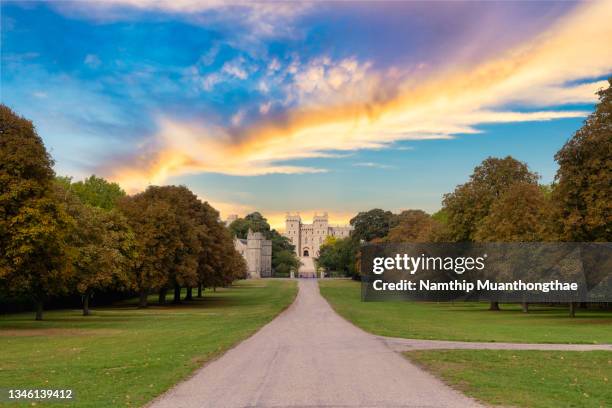 beautiful scenery of windsor castle with the forward long road shows the  autumn in europe with the beautiful old castle that located windsor, united kingdom. - windsor castle dusk stock pictures, royalty-free photos & images