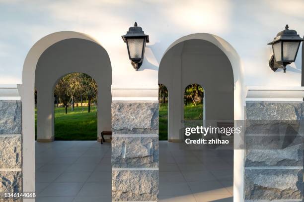 wall lamp at the door of the arch - sconce stock pictures, royalty-free photos & images