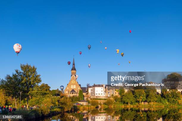 hot air balloons over the town of vielsalm, belgium - belgium landscape stock pictures, royalty-free photos & images