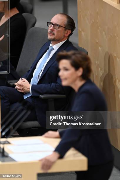 Newly appointed Austrian chancellor Alexander Schallenberg looks up as head of the Austrian Social Democratic Party Pamela Rendi-Wagner speaks during...