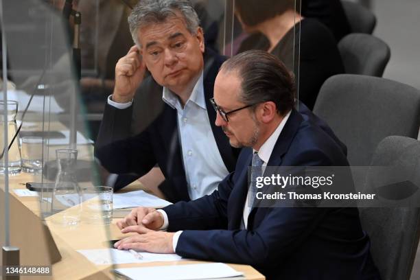 Vice-Chancellor Werner Kogler watches newly appointed Austrian chancellor Alexander Schallenberg checking his phone during a special session of the...