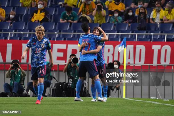 Ao Tanaka of Japan celebrates scoring his side's first goal with his team mate Maya Yoshida during the FIFA World Cup Asian qualifier final round...