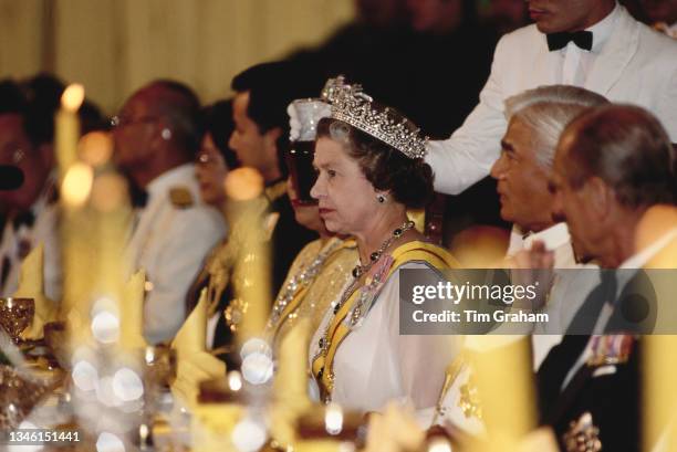 British Royal Queen Elizabeth II, wearing the Girls of Great Britain and Ireland tiara, Yang di-Pertuan Agong of Malaysia Azlan Shah of Perak , and...