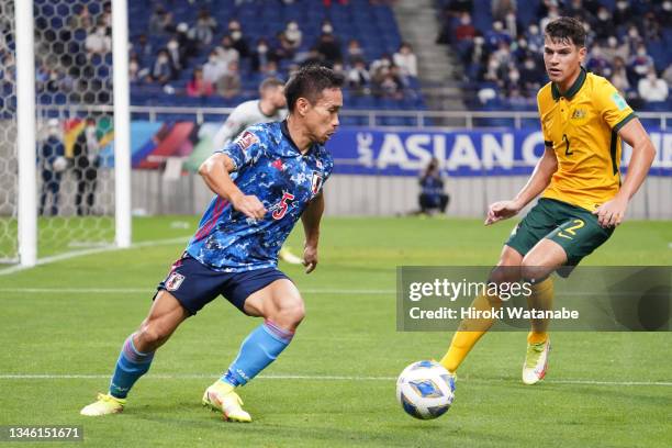 Yuto Nagatomo of Japan controls the ball under pressure of Fran Karacic of Australia during the FIFA World Cup Asian qualifier final round Group B...