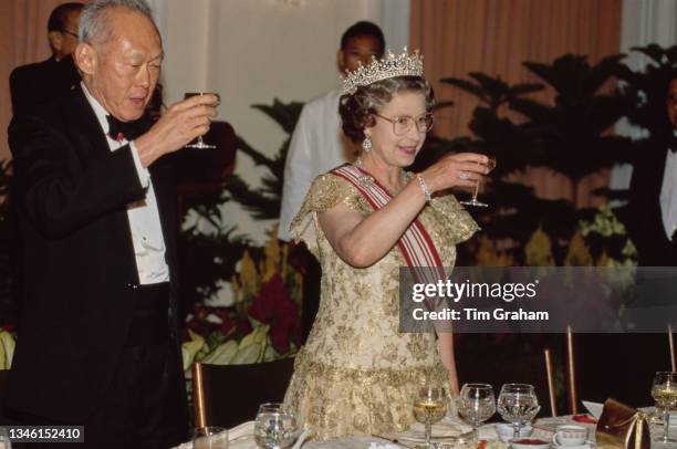 Prime Minister of Singapore Lee Kuan Yew and British Royal Queen Elizabeth II, wearing the Girls of Great Britain and Ireland diamond tiara, attend a...