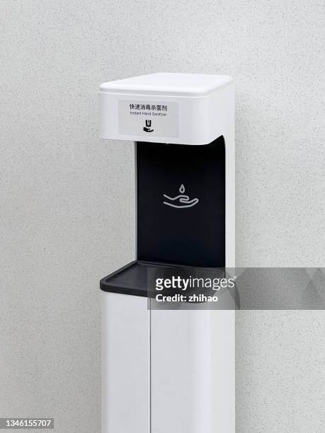 side view of automatic hand disinfection machine - dispenser foto e immagini stock