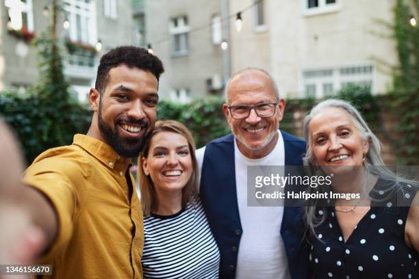 happy multiracial family taking selfie outdoors in garden. - happiness fotos stockfoto's en -beelden