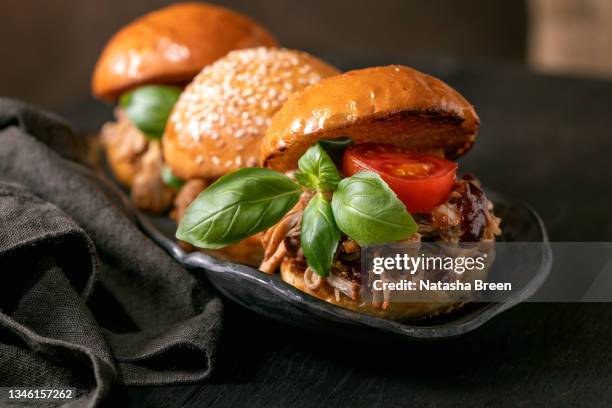 set of homemade mini burgers with stew beef - close up bread roll black backdrop horizontal stock pictures, royalty-free photos & images