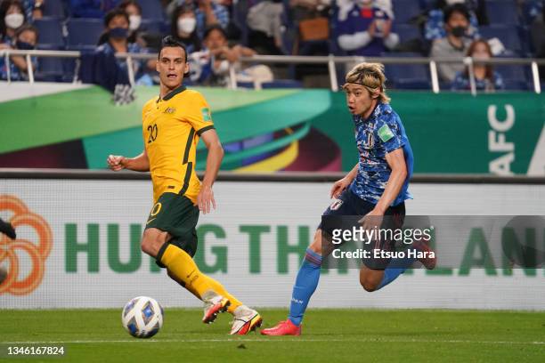 Trent Sainsbury of Australia and Junya Ito of Japan compete for the ball during the FIFA World Cup Asian qualifier final round Group B match between...