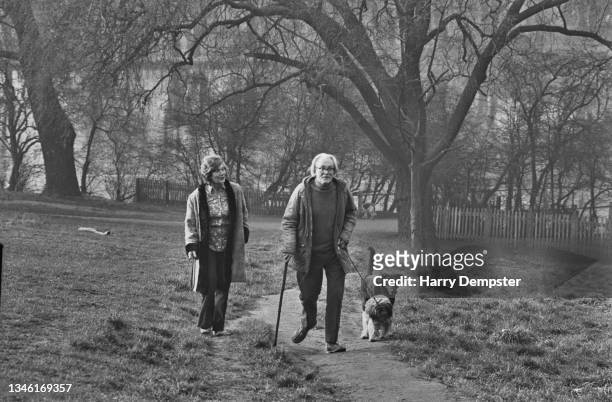 British Labour Party politician Michael Foot , the new Secretary of State for Employment, walking his dog on Hampstead Heath in London, with his...