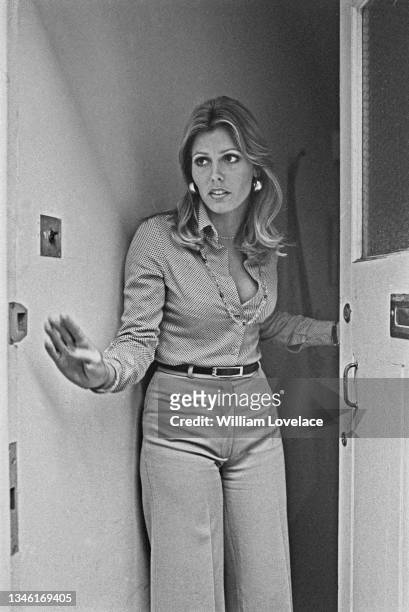 American beauty queen Marjorie Wallace, winner of the 1973 Miss World contest, appears at the door of her London flat on the day of the announcement...
