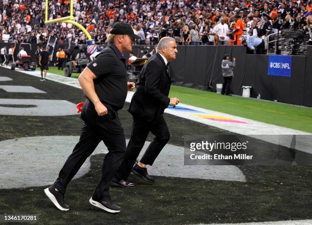 Head coach Jon Gruden of the Las Vegas Raiders and Raiders director of team security Bob Stiriti run off the field after the team's 20-9 loss to the...