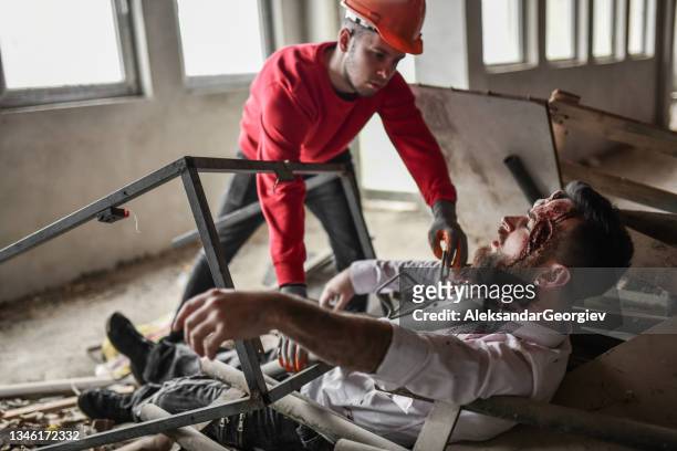 emergency serviceman finding and trying to save crushed male under debris after earthquake - concussion stock pictures, royalty-free photos & images