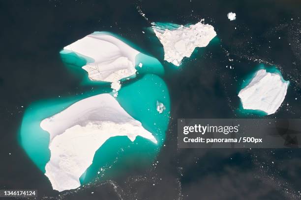 high angle view of icebergs in sea - landslag stock pictures, royalty-free photos & images