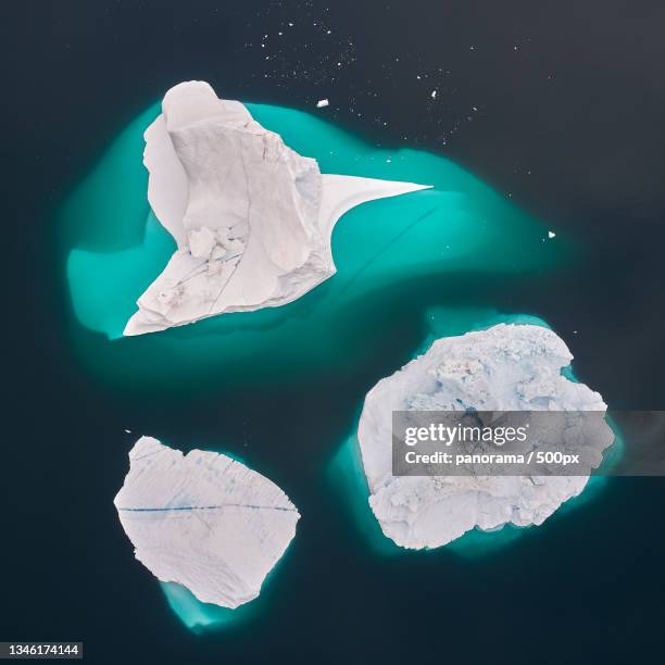 high angle view of icebergs in sea over greenland - landslag stock pictures, royalty-free photos & images