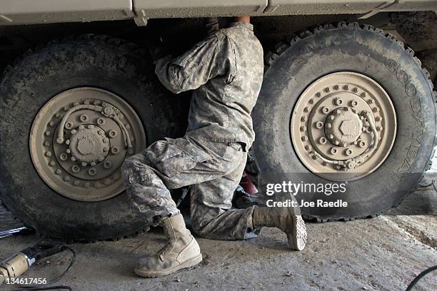 Army Specialist Joshua Landers from Sugar Land Texas of the 2-82 Field Artillery, 3rd Brigade, 1st Cavalry Division, changes a shock mount on a...