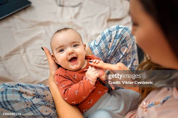 mother holding her baby - 4 months stock pictures, royalty-free photos & images