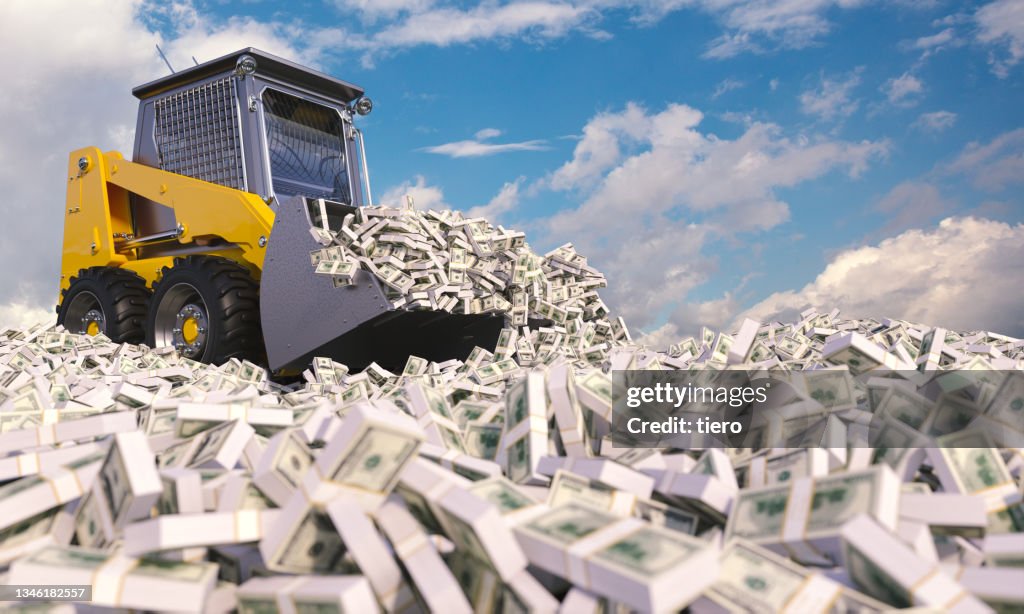 Yellow bulldozer making its way through piles of dollars.