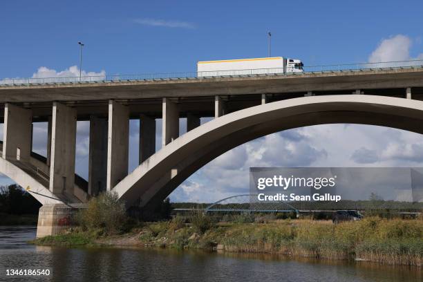 Trucks drive across a highway bridge over the Oder river that has become a common conduit for illegal migrants crossing from Poland into Germany as a...