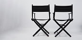 Back of black two director chair use in video production or movie and cinema industry on white background.