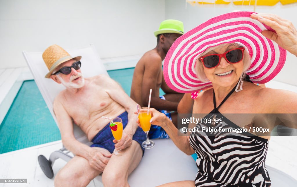 Senior Pool Fun Group Of Seniors Having Fun Together At Swimming Pool High-Res Stock ...