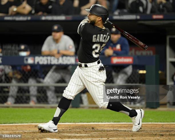 Leury Garcia of the Chicago White Sox hits a three-run home run in the third inning during Game Three of the American League Division Series against...