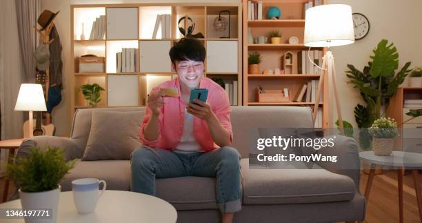 man shopping online with card - asian credit card imagens e fotografias de stock