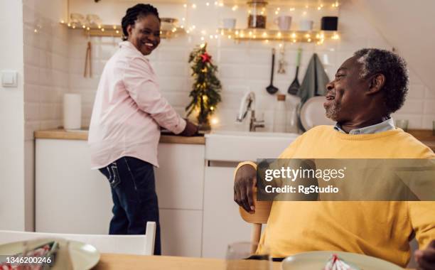 happy african american senior enjoying together for the new year's eve - 55 year old male stockfoto's en -beelden