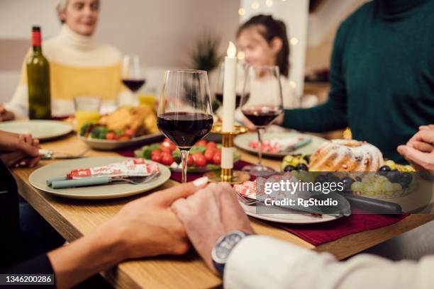 family praying before their new year's dinner - couple praying stock pictures, royalty-free photos & images