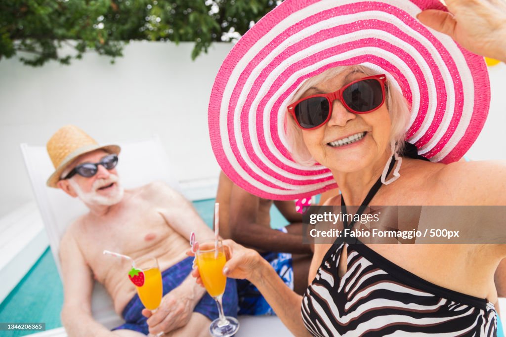 Senior Pool Fun Group Of Seniors Having Fun Together At Swimming Pool High-Res Stock ...