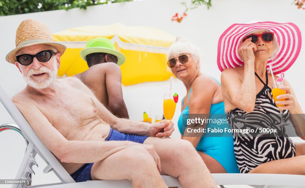 Senior Pool Fun Group Of Seniors Having Fun Together At Swimming Pool High-Res Stock ...