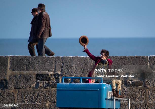 Timothée Chalamet is seen as Willy Wonka leaving the ship on the top of a van during filming for the Warner Bros and the Roald Dahl Story Company's...