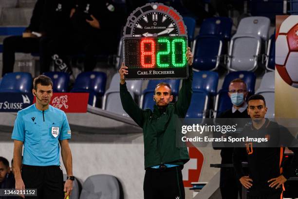 Referee Andrija Stojanovic shows a Carl F. Bucherer substitution board during the UEFA European Under-21 Qualifiers match between Switzerland and...