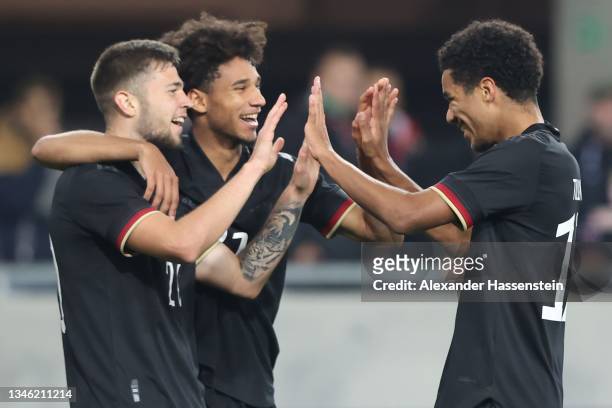 Eric Shuranov of Germany celebrates scoring the 3rd team goal with his team mates Kevin Schade and Malik Tillman during the 2022 UEFA European...