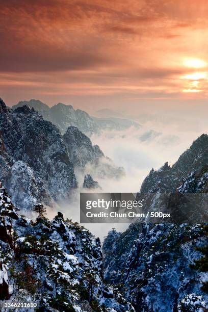 scenic view of snowcapped mountains against sky during sunset,huangshan mountain,china - huangshan mountains stock pictures, royalty-free photos & images