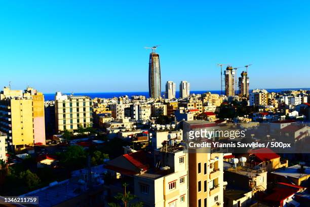 high angle view of buildings in city against clear blue sky,limassol,cyprus - limassol stock pictures, royalty-free photos & images