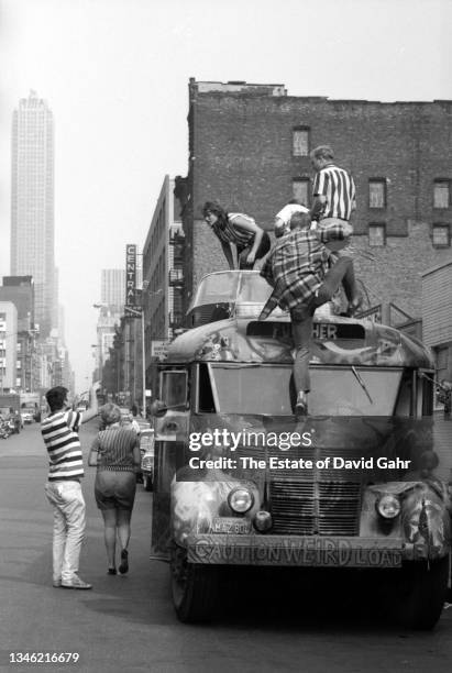 American novelist and counterculture figure Ken Kesey and members of The Merry Pranksters, stand atop of Further, the legendary Day-Glo Bus, in June...