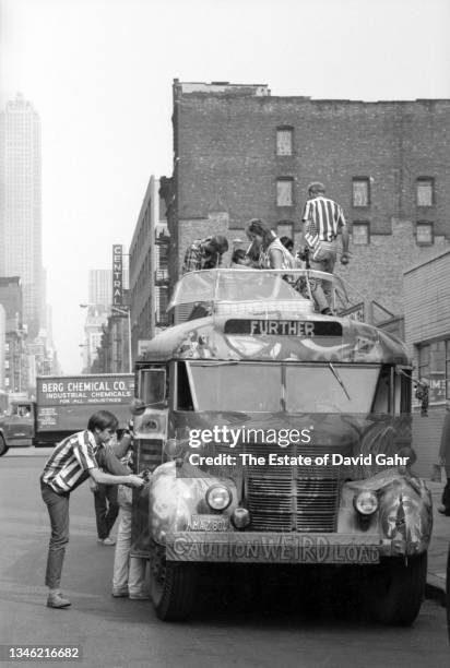 American novelist and counterculture figure Ken Kesey and members of The Merry Pranksters, stand atop of Further, the legendary Day-Glo Bus, in June...