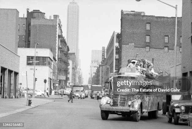American novelist and counterculture figure Ken Kesey and members of The Merry Pranksters, stand atop of Further, the legendary Day-Glo Bus, in June...