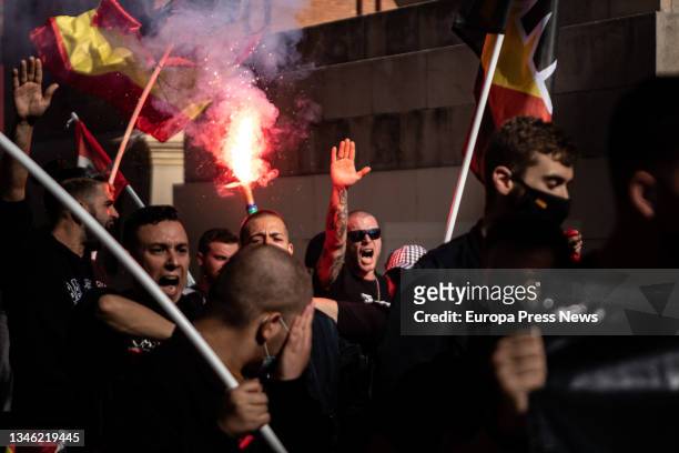 Neo-Nazi youths with flares raise their arms during a neo-Nazi demonstration to celebrate Columbus Day, October 12 in Barcelona, Catalonia, Spain....