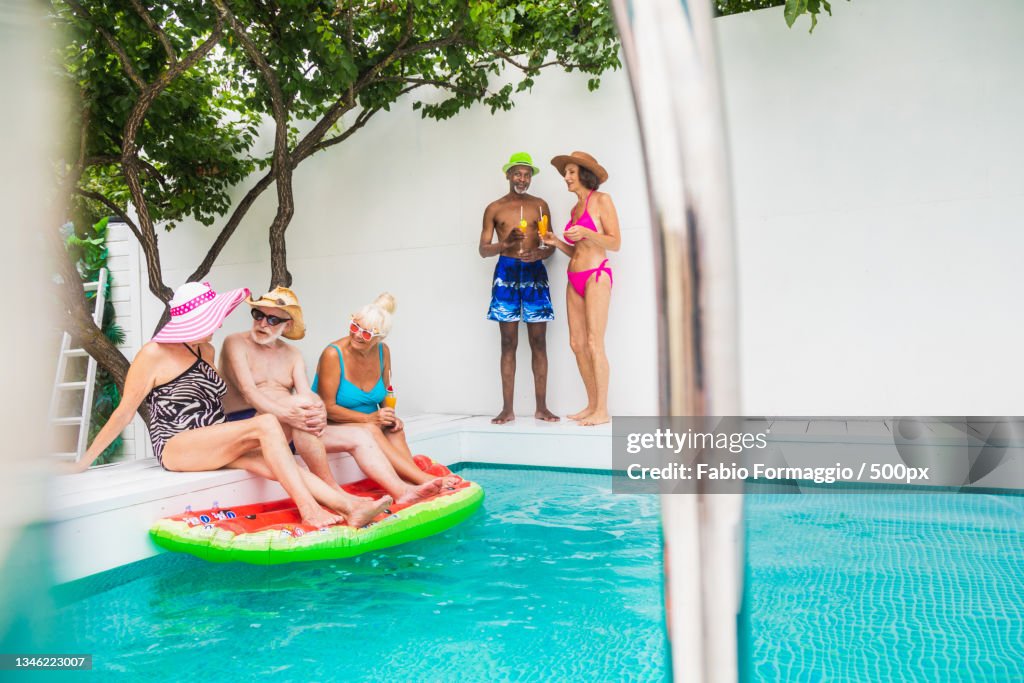 Senior Pool Fun Group Of Seniors Having Fun Together At Swimming Pool High-Res Stock ...