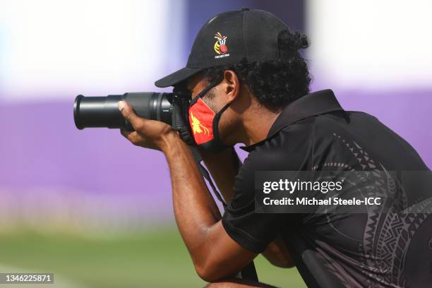 Member of the Papua New Guinea takes a photograph during the Paua New Guinea and Ireland warm Up Match prior to the ICC Men's T20 World Cup at on...